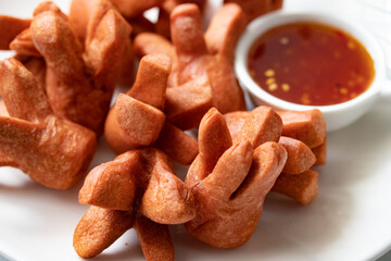 Close-up, crispy sausage with spicy chili sauce