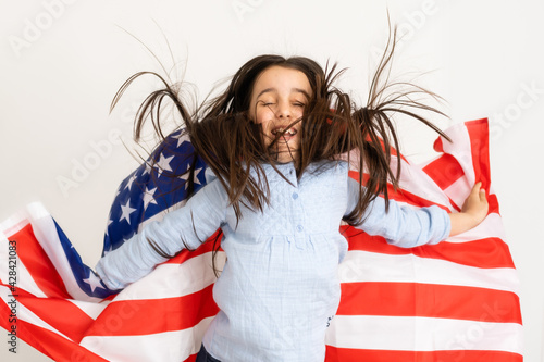 child holds a flag of America, USA.
