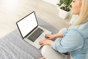 Rear view of business woman hands busy using laptop at office desk, with copyspace