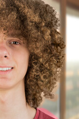 split in half cropped portrait of a young curly European man with long curly hair and a dreamy...
