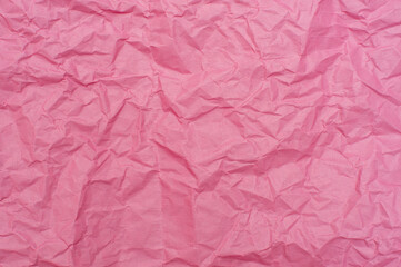 Crumpled pink background. Pink paper, texture and backgrounds.
