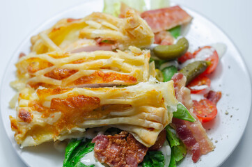 Chicken en croute, chicken breast inner fillets with mature cheddar cheese and beechwood smoked streaky bacon in a puff pastry lattice