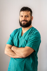 Portrait of young male medical staff in green uniform with stethoscope on white background. Medical healthcare doctor service concept.