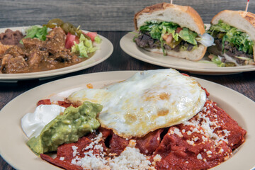 Feast of Mexican food awaits on the table with breakfast, lunch, and dinner represented with each plate.