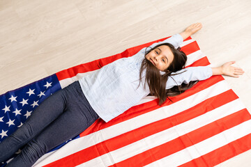 Portrait of a little girl with the flag of America. American education, study in America