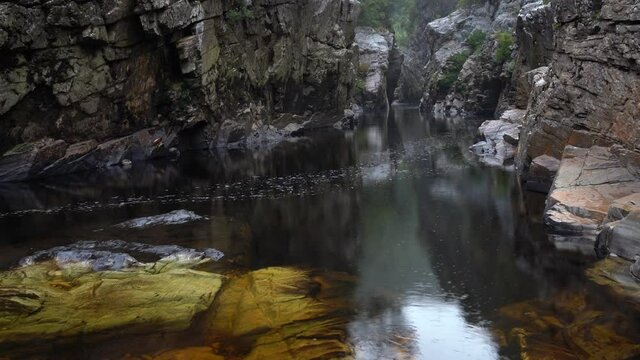 Gentle Rain on the calm waters of The Irenabyss (chasm of peace), The Franklin River. Tasmania, Australia. World Heritage Area (WHA). Southwest Wilderness.