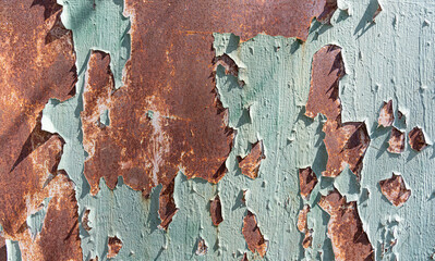 Rusty old metal texture with peeling paint as abstract background.