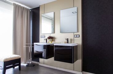Fototapeta na wymiar Modern Bathroom interior with gold metallic brushed brass wall and with black sinks. Contemporary bathroom with copy space