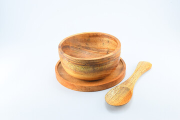 Mahogany bowl with spoon and wooden placemat on isolated white background