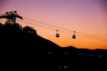 Low angle shot to two cable cars of Hong Kong Ngong Ping 360 in dusk.