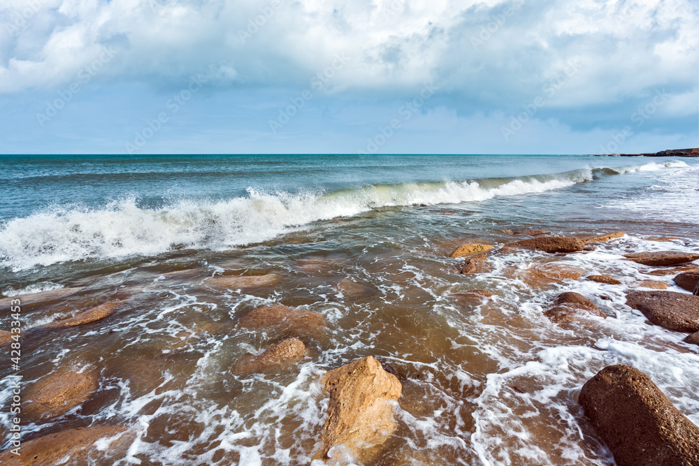 Wall mural Sea beach with large boulders