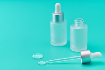 a drop of hydrating facial serum on a blue background.