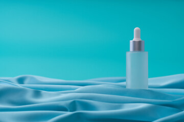 medical skin care, bottle for serum, micellar toner on blue background,selective focus.