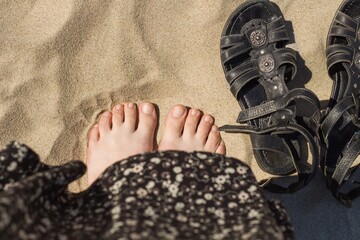 human feet on the sea sand