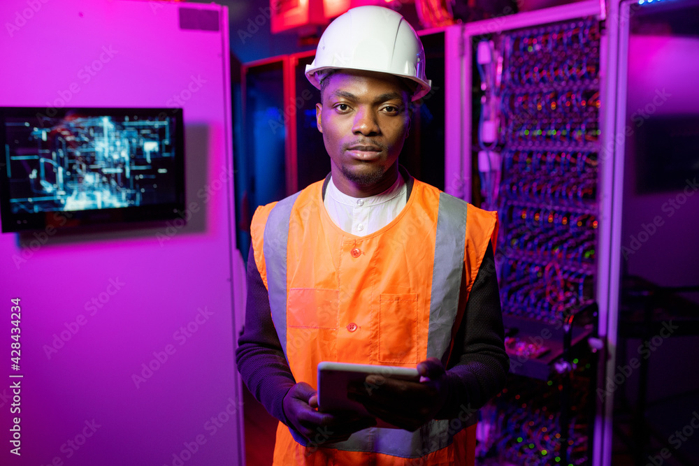 Poster portrait of data center engineer in orange vest