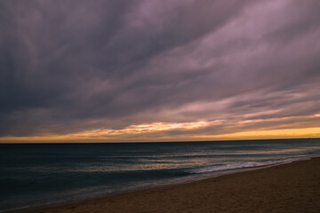 Sunset with windy clouds over the sea.