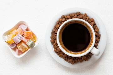 Coffee and coffee grains. Turkish delight next to Turkish coffee.