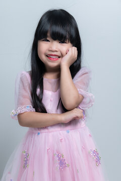Portrait asian cute little girl pose for take a photo in studio on white background