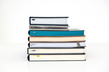 A stack of paper books or diaries for writing on a white background