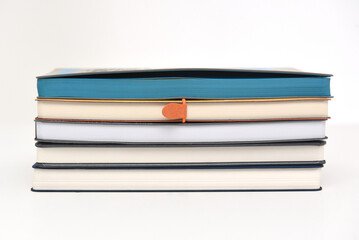 A stack of paper books or diaries for writing on a white background