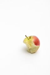 A ripe red apple isolated on a white background. Red bitten apple on white background. Apple Clipping Path. Vertical photo an apple stub.