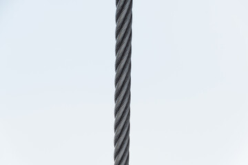 Steel twisted rope on light background. Splitting frame into two parts
