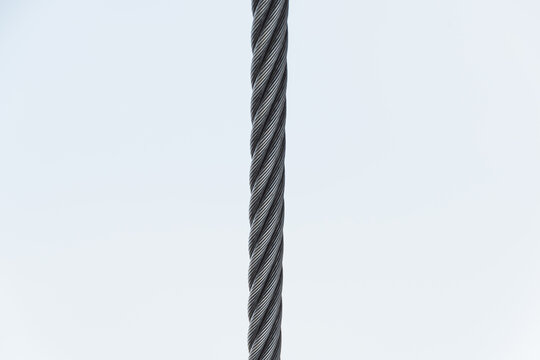 Steel twisted rope on light background. Splitting frame into two parts