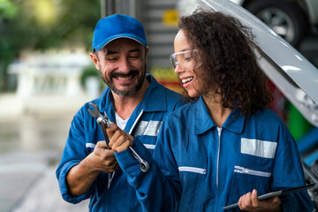 The car mechanic is having fun with his work. Auto mechanic hands using wrench to repair a car...