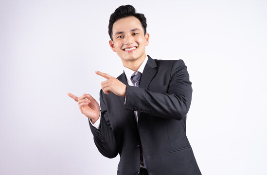 Image of young Asian businessman wearing suit on white background