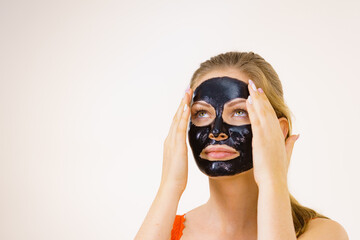 Girl black carbo peel off mask on face