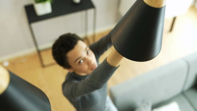 African American Changing Broken Light Bulb