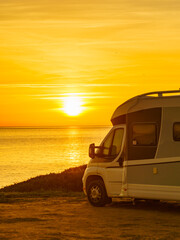 Fototapeta na wymiar Camper vehicle on beach at sunrise