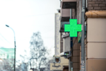Green pharmacy cross on corner of building - 428443263