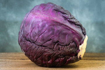 Head of red cabbage on wooden table