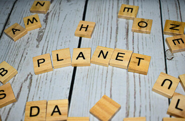 Wooden blocks with letters forming word "planet"