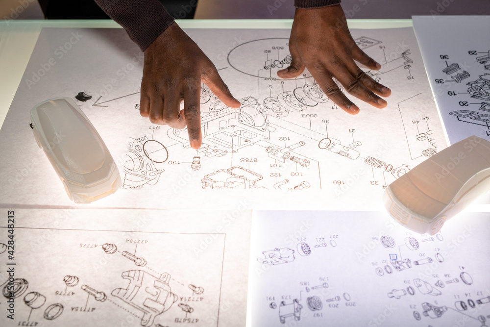 Poster automotive engineer analyzing sketches