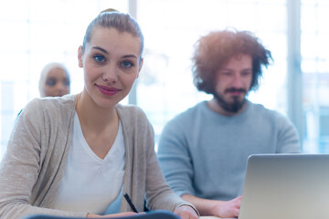 Group of people listening to a presentation speech and working and communicating together in creative office