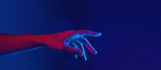 male hand touching or pointing in neon red blue lighting, web banner - obrazy, fototapety, plakaty