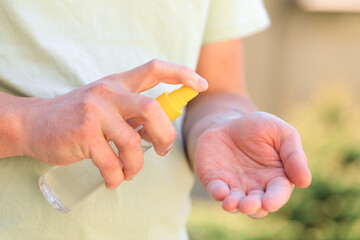Obraz na płótnie Canvas hand disinfection with an antiseptic spray as prevention of coronavirus - Image