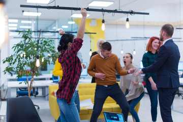 Business winners. Full length of group of happy young people in formal wear celebrating, gesturing, keeping arms raised and expressing positivity © as-artmedia
