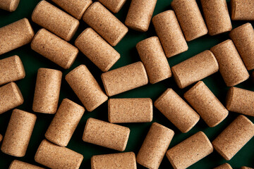 Many of cork plugs for the wine bottle in detail. Background texture of a randomly scattered pile of assorted wine corks. Wine and alcohol theme.