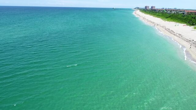 wide shot on ocean and man parasailing