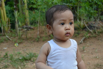 Cute little boy playing outside the house