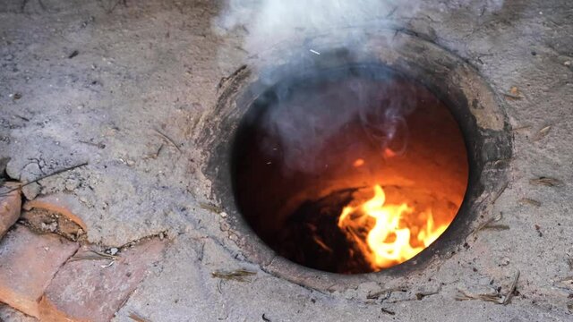 Burning tandoor well.  Concrete tandoor fired for cooking.