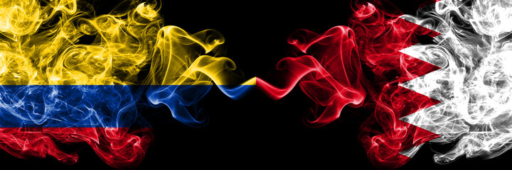 Colombia, Colombian vs Bahrain, Bahraini smoky mystic flags placed side by side. Thick colored silky abstract smokes flags.