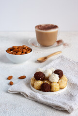 Healthy breakfast with sweet balls of organic farm goat cheese with nuts and coffee