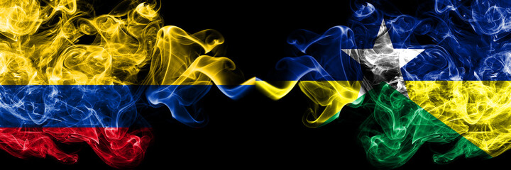 Colombia, Colombian vs Brazil, Brazilian, Rondonia  smoky mystic flags placed side by side. Thick colored silky abstract smokes flags.