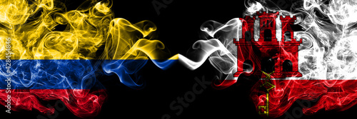Colombia, Colombian vs British, Britain, Gibraltar smoky mystic flags placed side by side. Thick colored silky abstract smokes flags.