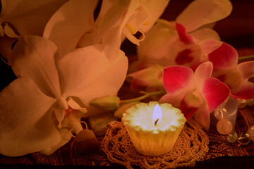 Fototapeta na wymiar aroma candle with orchid flowers