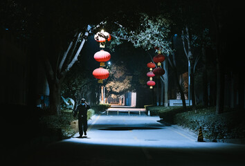 A man walks down the street at night